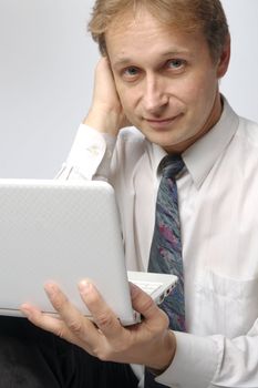 Portrait of middle-aged man with a white laptop computer