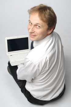 Portrait of middle-aged man with a white laptop computer