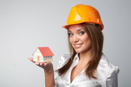 Little House in the hands of young and beautiful business woman