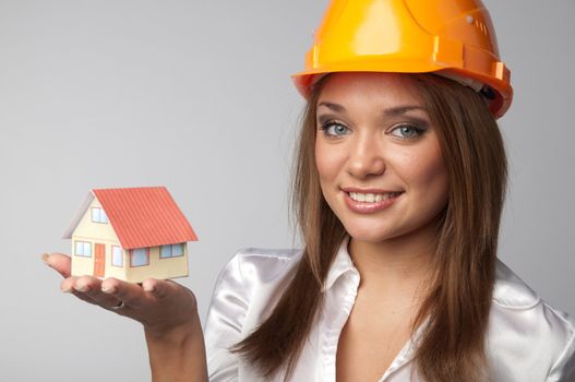 Little House in the hands of young and beautiful business woman