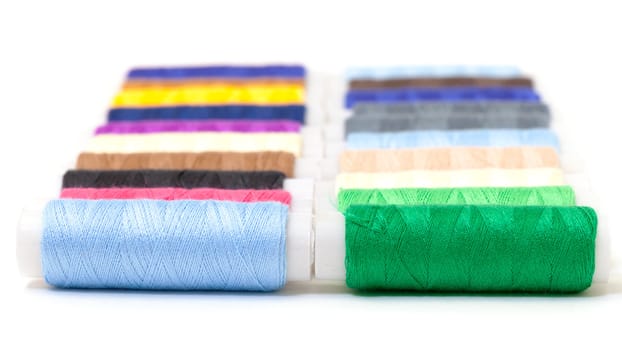 Several Multicolor Spools of Thread on white background