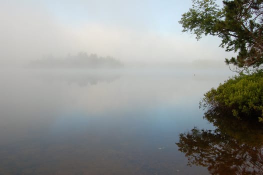 Strobg fog above lake in the morning
