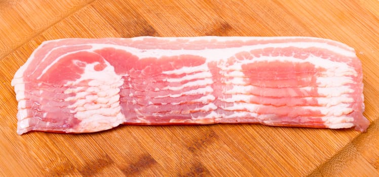 Fresh Sliced Bacon, on wood background