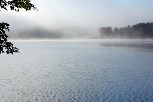 Fog above lake in the morning
