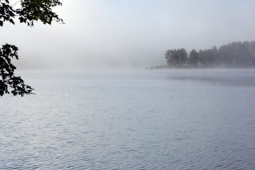 Fog above lake in the morning
