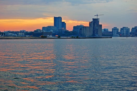 Toronto skyline from Ontario lake in time of sunset
