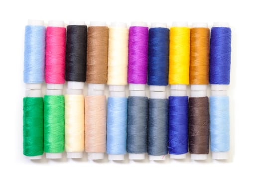 Several Multicolor Spools of Thread on white background