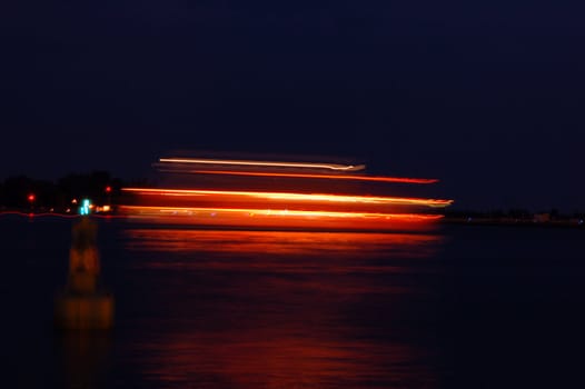 Moving pleasure boat with lighgts on