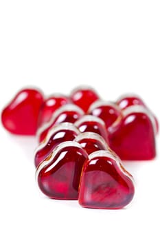 Red heart shaped gems on white background