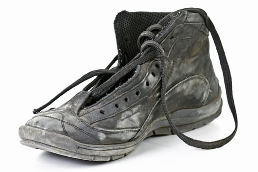 Old worn out black shoes on white background