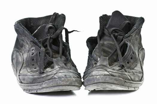 Old worn out black shoes on white background