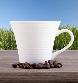 Close up of a cup of coffee with coffee beans