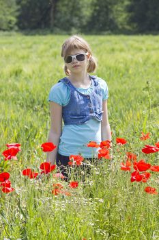 Cute young girl in poppy field