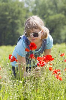 Cute young girl in poppy field
