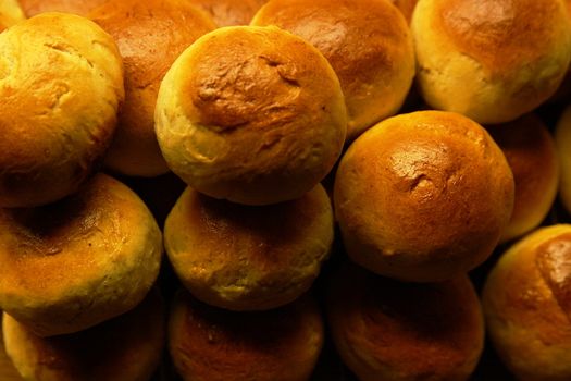 Golden wheat buns freshly baked, straight from the oven