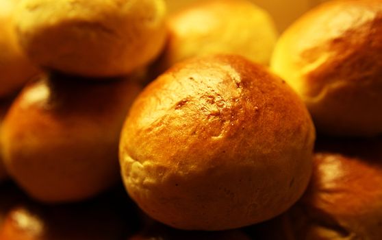 Golden wheat buns freshly baked, straight from the oven