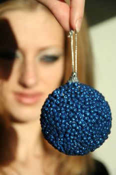 The cheerful woman has control over a fur-tree toy