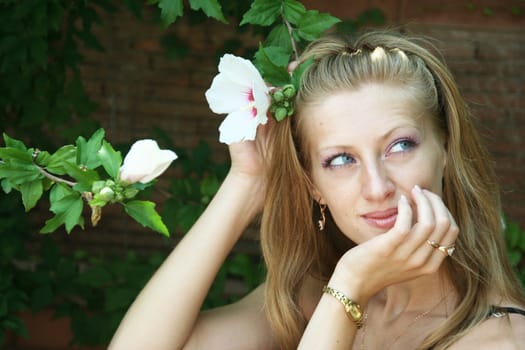 The young girl with a beautiful flower