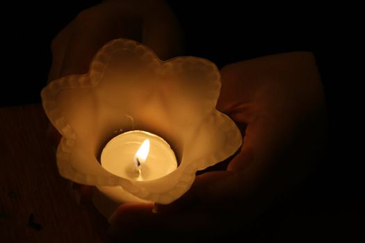 In my hands the candle burns giving light to my hope