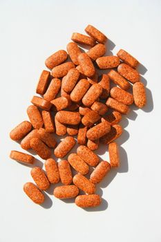 Close up of pills on a white background.
