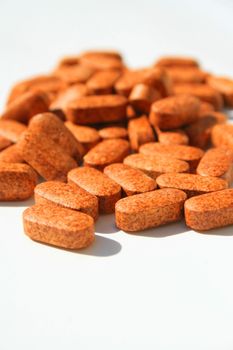 Close up of pills on a white background.
