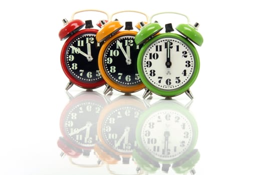timing red yellow and green alarm clock untill twelve oclock closeup with nice reflection