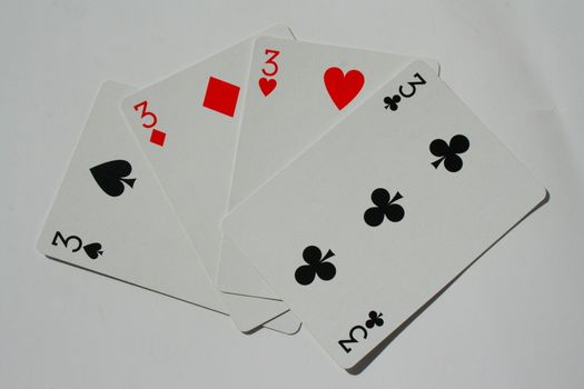 Close up of four threes on a white background.
