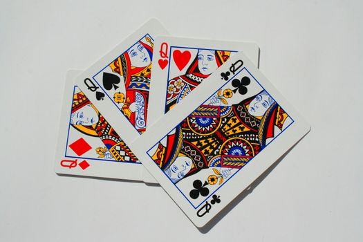 Close up of four queens on a white background.
