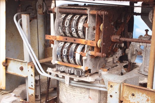 the gears and cogs of an old fuel dispensing pump