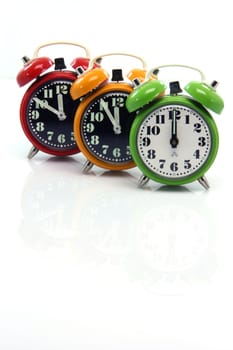 timing red yellow and green alarm clock untill twelve oclock closeup with nice small reflection vertical