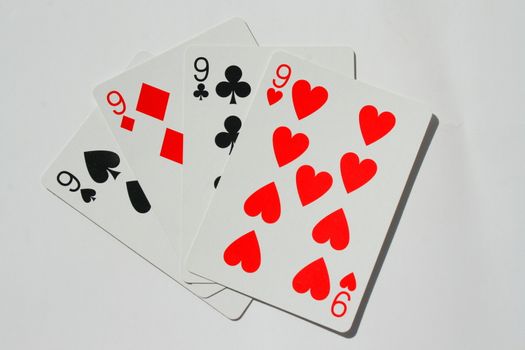 Close up of four nines on a white background.
