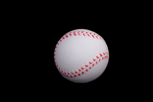 White baseball isolated on black background.           