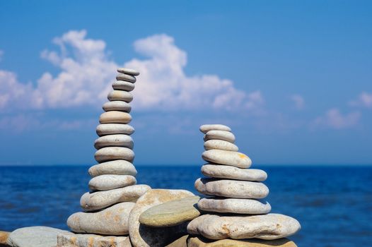 Two pile of pebbles in the balance on the seacoast