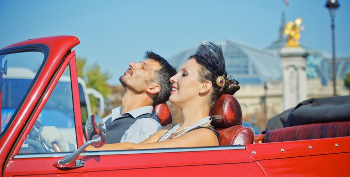 Romance in Paris. Young happy couple in retro-style travel in a car in Paris