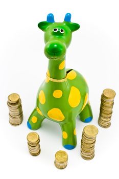 Giraffe money-box surrounded by towers of the coines