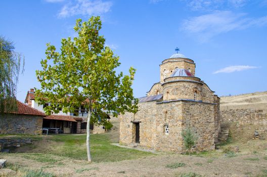ancient church with green tree and blue sky. St. Nikola old church near ancient town ruins Bargala in Macedonia
