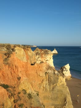 Red rocks in the afternoon sun on the Algarve coast. Portugal
