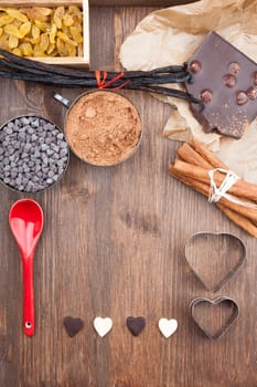 Ingredients for baking chocolate on a dark wooden background