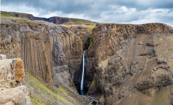 Panorama of Hengifoss is the second highest waterfall on Iceland. The most special thing about the waterfall are multicolored layers in the basalt rock behind waterfall