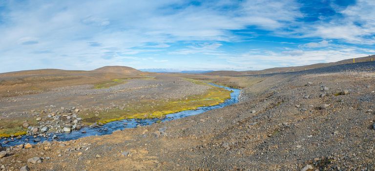 Glacier great fast blue river with green banks in Iceland. Panorama