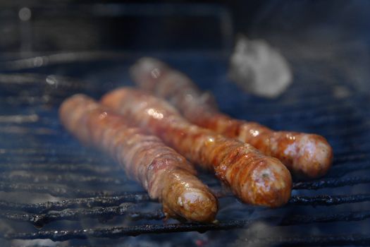 grilling outdoors on a wood barbecue grill.