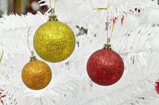new year and christmass balls on white pine background