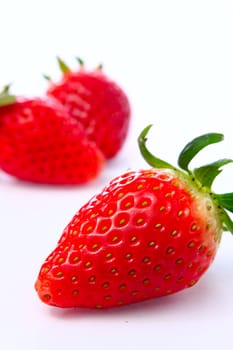 Three stawberries on the white background 