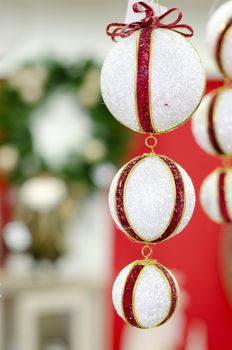 Merry Christmas and Happy new year, New Year's white ball with red ribon on a red background abstract background lights