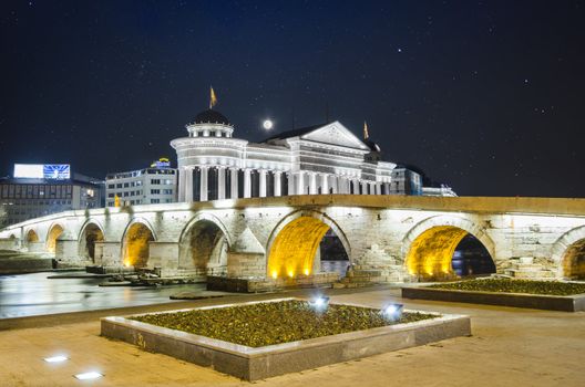 beautiful old stone bridge and archeological museum of Macedonia on star sky and moon