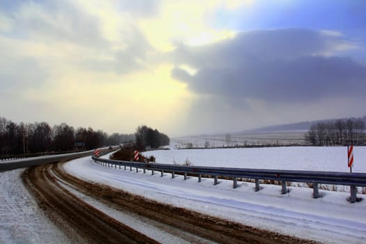 Image of winter road and cloudy sky