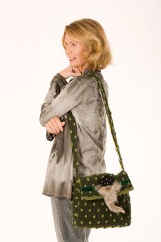 older lady posing with green designer handbag