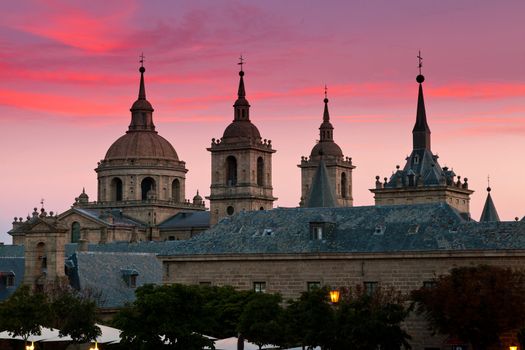 San Lorenzo de El Escorial Monastery  with beautiful sky right after sunset. Four towers are set off by sky with pink and purple hues.