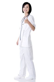 Young female doctor or nurse gesturing OK. Isolated on white.