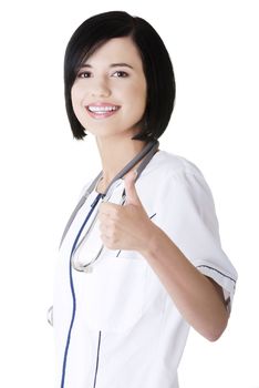 Young female doctor or nurse gesturing OK , isolated